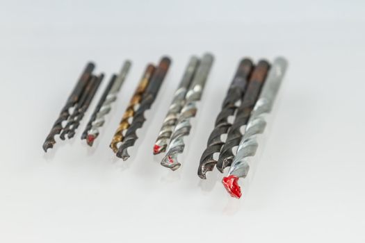 Assorted drill bits on isolated white background