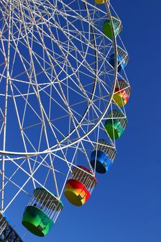 Brightly coloured gondola cabins of the Ferris Wheel at Luna Park Sydney.