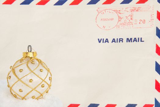 An old air mail envelope with a white and gold christmast bulb