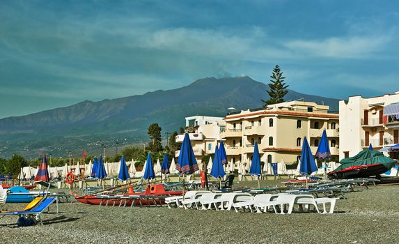 The beach in Sicily with views of Mount Etna. Resort area of Giardin Naxos.