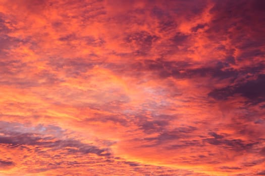 Cloudy sky, red in the evening sunlight.