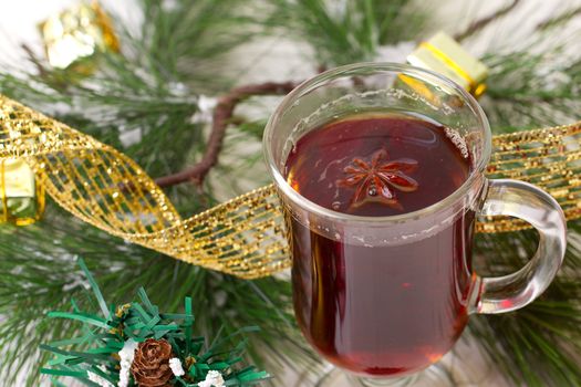 Christmas mug with tea decorated  with red and green snowflakes pine and fir cone ornament