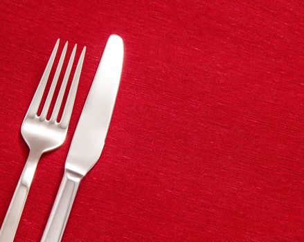 Silver Fork and knife on red table cloth