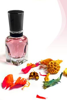 Perfume bottle and fragrance flowers on white