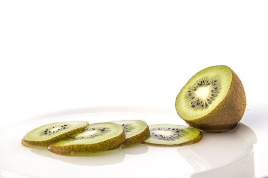 Kiwi on a white dish and sliced