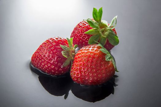 Three fresh strawberries inside water