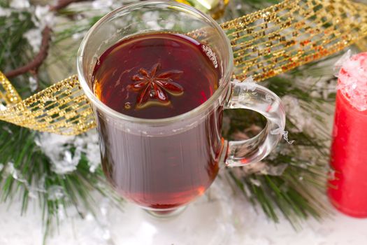 Christmas mug with tea decorated  with red and green snowflakes pine and fir cone ornament