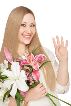 Smiling xxl woman waving at camera, holding pink and white lily flowers