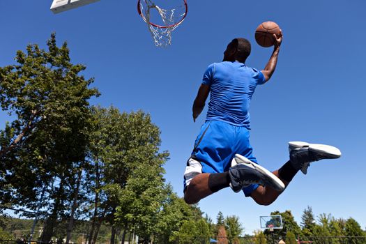 A young basketball player driving to the hoop with some fancy moves.