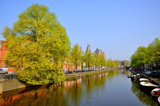 Beautiful river with boats in Amsterdam, Holland (Netherlands)