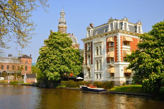 Beautiful river with boats in Amsterdam, Holland (Netherlands)