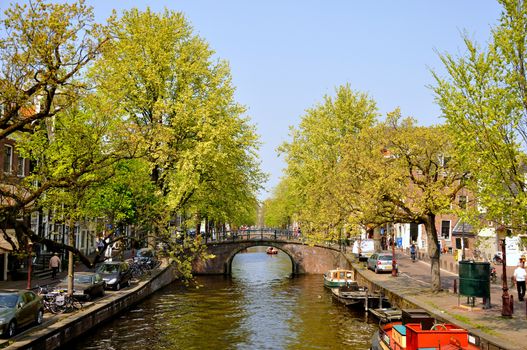 Beautiful river with boats and bridge in Amsterdam, Holland (Netherlands)