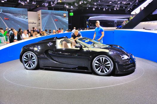 FRANKFURT - SEPT 14: Bugatti Veyron Grand Sport LOr Blanc presented as world premiere at the 65th IAA (Internationale Automobil Ausstellung) on September 14, 2013 in Frankfurt, Germany