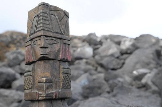 Ancient Maya Statue on the Rocks near the Ocean