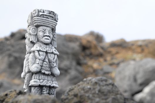 Ancient Maya Statue on the Rocks near the Ocean