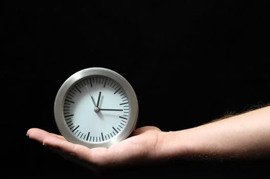 Clock And an Hand on a Black Background