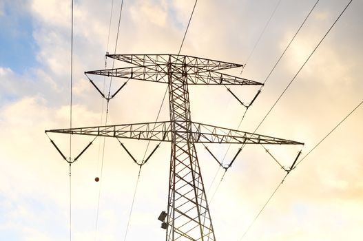 Power Electric Tower on a Cloudy Sky at Sunset