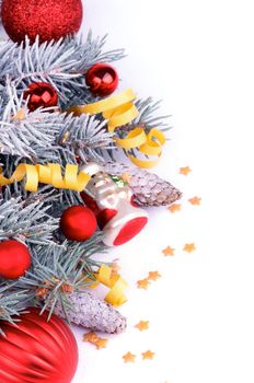 Arrangement of Spruce Branch with Hoar-Frost, Decorative Snowman, Red Baubles, Fir Cones, Gold Stars and Party Streamer as Frame isolated on white background