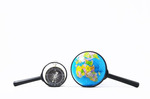 Orientation Concept Earth,Magnify Glass and Compass on a White Background