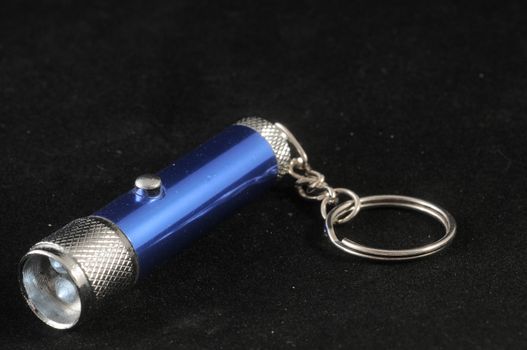 One Blue Aluminum Led Torch on a Black Background