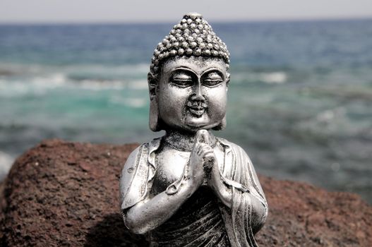 One Ancient Gray Buddha Statue Near The Ocean