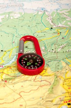 An image of red pocket compass and road map