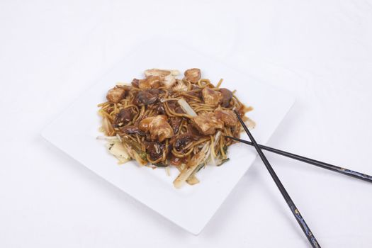 cooked noodles with pieces of chicken breast and vegetables in savoury mushroom sauce