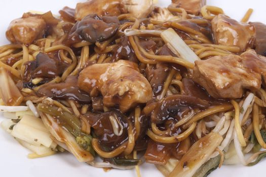 cooked noodles with pieces of chicken breast and vegetables in savoury mushroom sauce