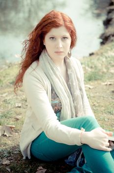 beautiful young woman posing in the park of the city