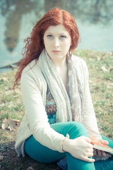 beautiful young woman posing in the park of the city