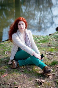 beautiful young woman posing in the park of the city