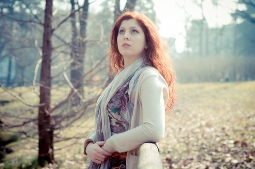 beautiful young woman posing in the park of the city