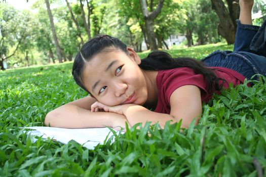 Girl in the park reading book