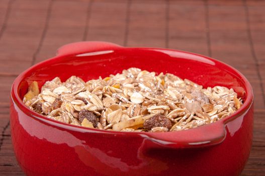 An image of hewalthy muesli in red ceramic bowl