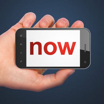 Timeline concept: hand holding smartphone with word Now on display. Generic mobile smart phone in hand on Dark Blue background.