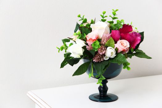 Colorful Artificial flower on white table