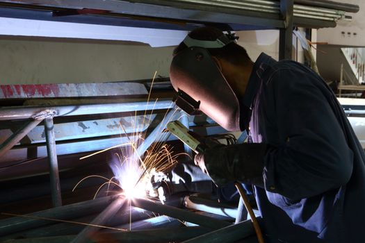 Worker welding iron frame structure