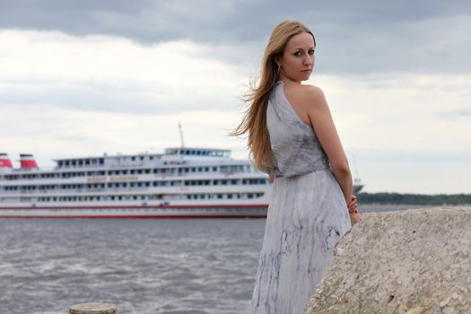 sad woman standing on the shore