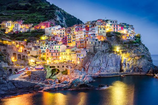 Scenic night view of colorful village Manarola in Cinque Terre, Italy