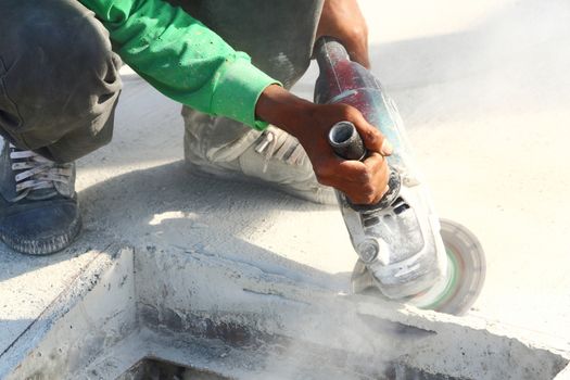 Worker use angle grinder to cut concrete
