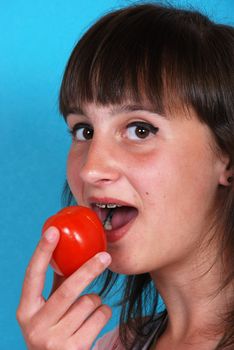 Girl eating a tomato