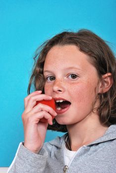 Girl eating a tomato