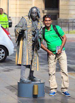 BARCELONA, SPAIN - APRIL 16: Human statue dressed as Christopher Columbus performing on La Rambla on April 16, 2013 in Barcelona, Spain. La Rambla is most popular street in Barcelona