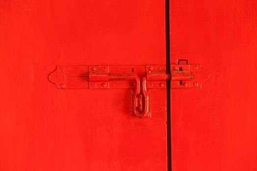 Red door with red bolt