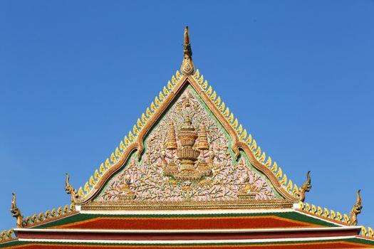 Thai temple art on temple roof on blue sky