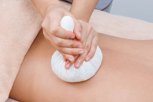 Herbal compress ball massage in Thai spa
