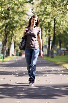 Beautiful young woman walking on the street
