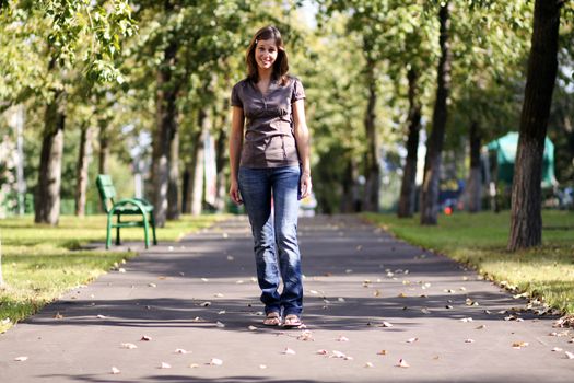 Beautiful young woman walking on the street