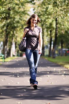Beautiful young woman walking on the street
