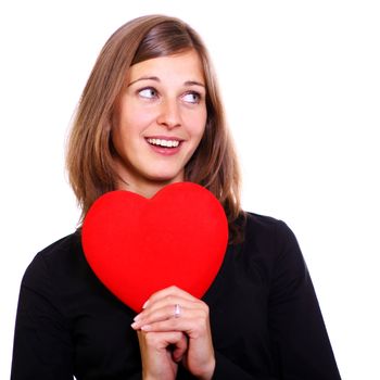 Portrait of a attractive young woman holding a red heart over white background